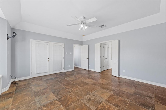 unfurnished bedroom with stone finish floor, visible vents, and baseboards