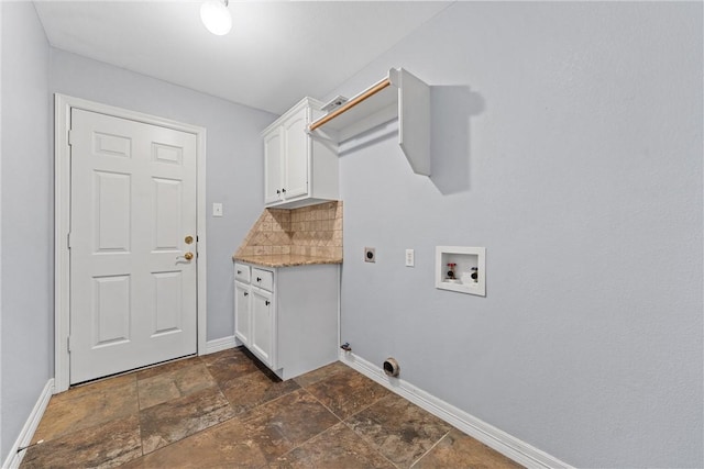 clothes washing area with hookup for a washing machine, cabinet space, stone finish floor, electric dryer hookup, and baseboards