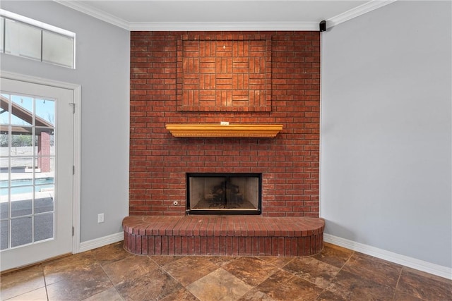 unfurnished living room featuring ornamental molding, stone finish flooring, a fireplace, and baseboards