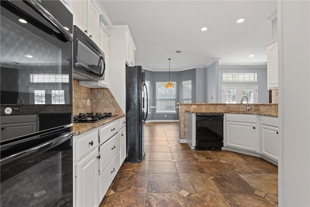 kitchen with black appliances, white cabinetry, and crown molding