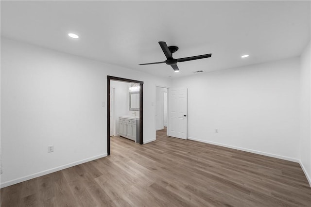 unfurnished bedroom featuring ceiling fan, light hardwood / wood-style floors, and ensuite bathroom