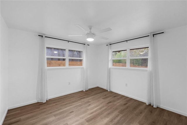 empty room featuring hardwood / wood-style floors and ceiling fan