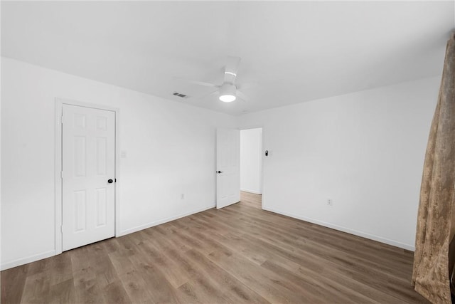 unfurnished room featuring hardwood / wood-style flooring and ceiling fan