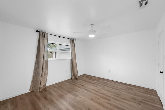 spare room featuring hardwood / wood-style floors and ceiling fan