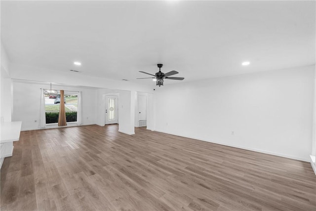 unfurnished living room featuring ceiling fan and light hardwood / wood-style floors