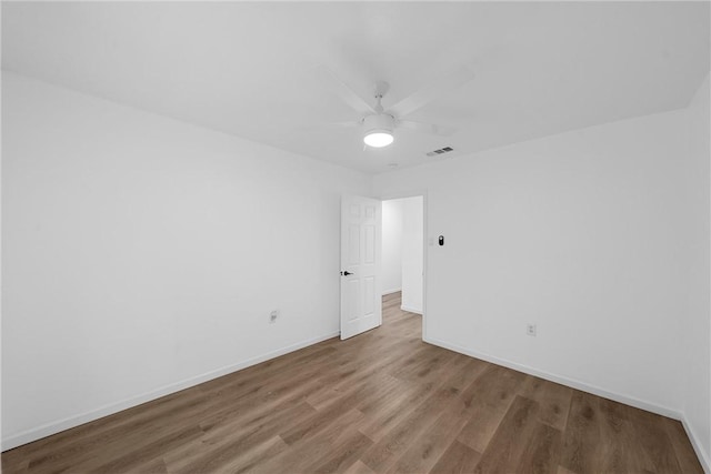 unfurnished room with ceiling fan and wood-type flooring