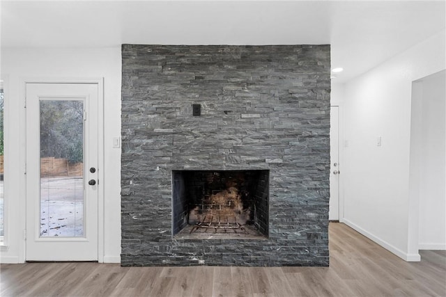 details with hardwood / wood-style floors and a fireplace