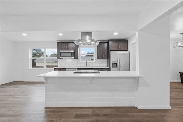 kitchen featuring decorative backsplash, dark hardwood / wood-style floors, dark brown cabinetry, and stainless steel appliances