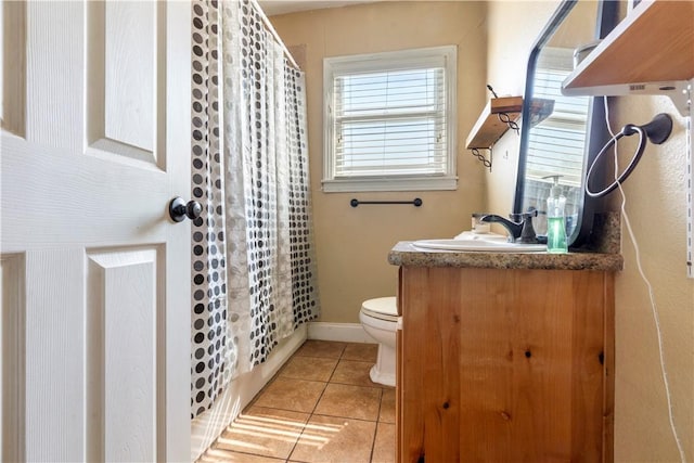 bathroom featuring tile patterned flooring, vanity, and toilet