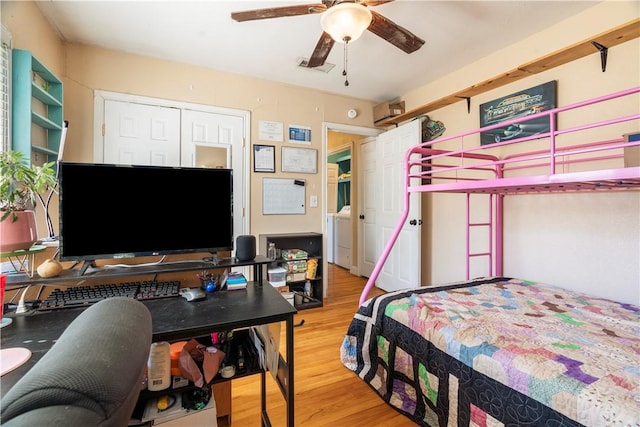 bedroom featuring a closet, hardwood / wood-style flooring, and ceiling fan