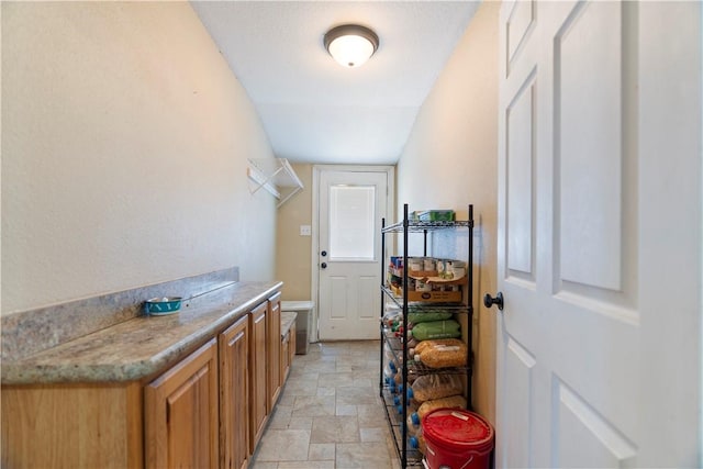 clothes washing area featuring cabinets and separate washer and dryer