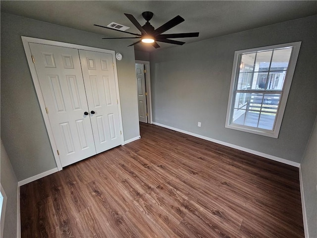 unfurnished bedroom featuring ceiling fan, a closet, and hardwood / wood-style floors