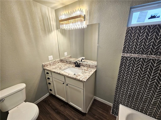 bathroom with toilet, a shower, wood-type flooring, and vanity