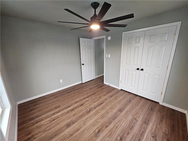 unfurnished bedroom featuring ceiling fan, hardwood / wood-style floors, and a closet