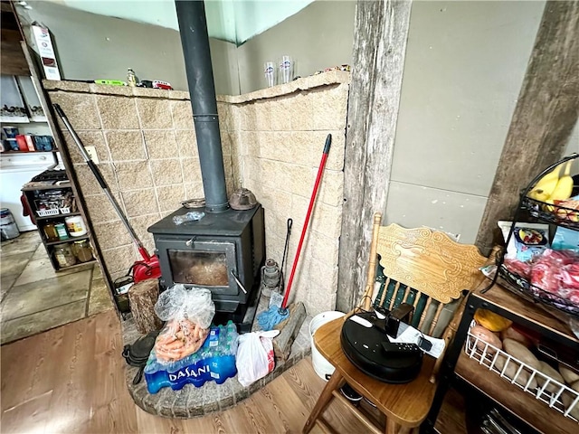 interior details with hardwood / wood-style flooring and a wood stove