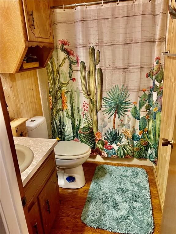 bathroom with hardwood / wood-style floors, vanity, and toilet