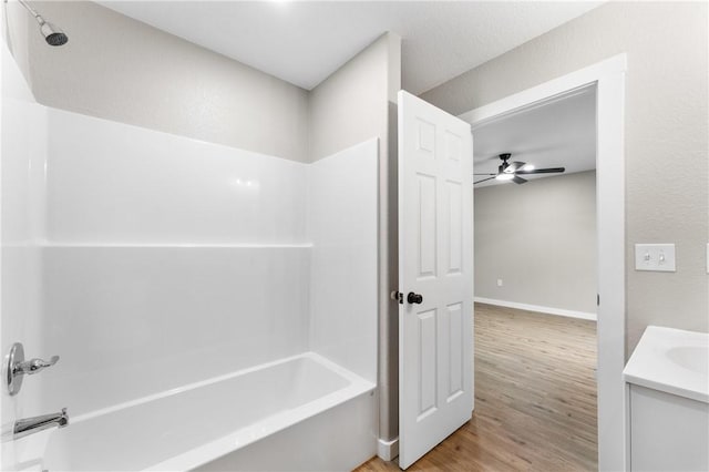 bathroom with vanity, shower / bathing tub combination, wood finished floors, and ceiling fan