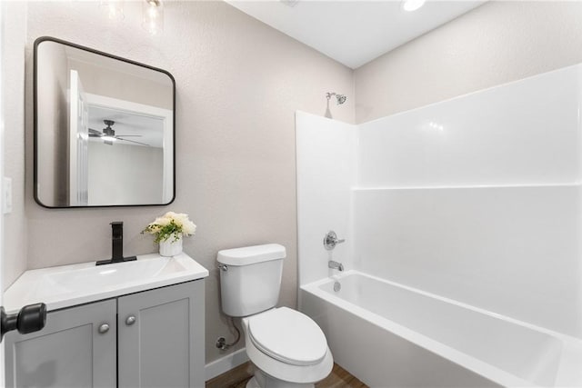 full bathroom featuring toilet, a ceiling fan, vanity, baseboards, and shower / bathtub combination