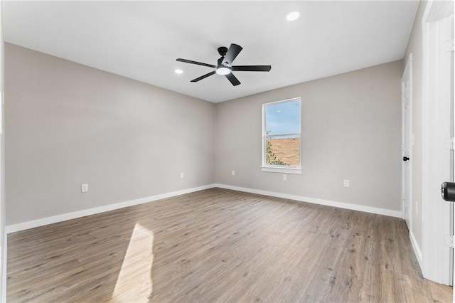 spare room with light wood finished floors, recessed lighting, baseboards, and ceiling fan