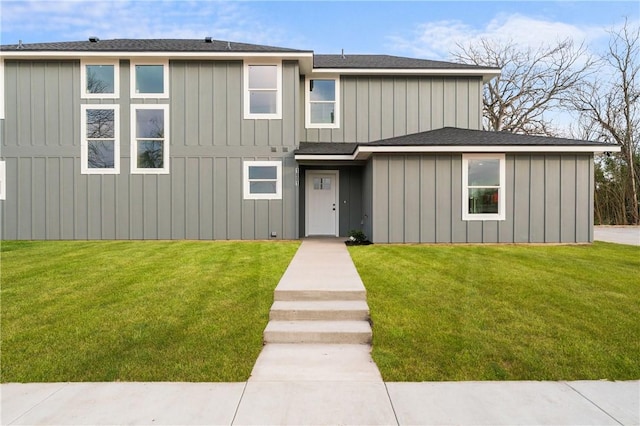 view of front of property with a front yard and board and batten siding