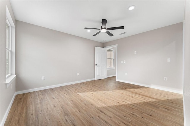 empty room featuring a ceiling fan, baseboards, visible vents, recessed lighting, and light wood-type flooring