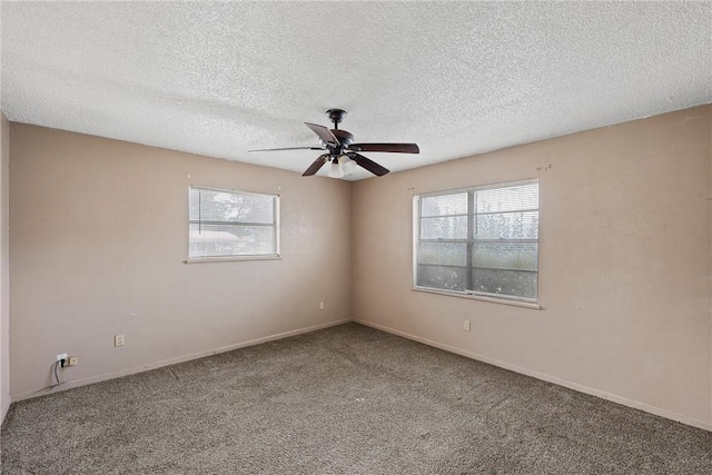 carpeted empty room featuring ceiling fan, baseboards, and a textured ceiling