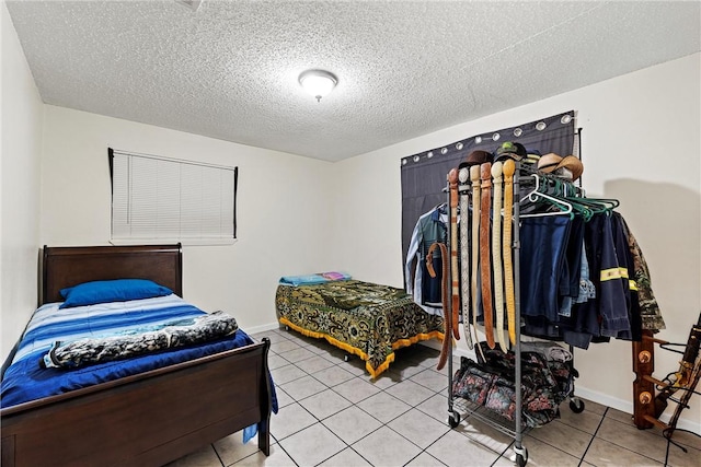 tiled bedroom featuring a textured ceiling