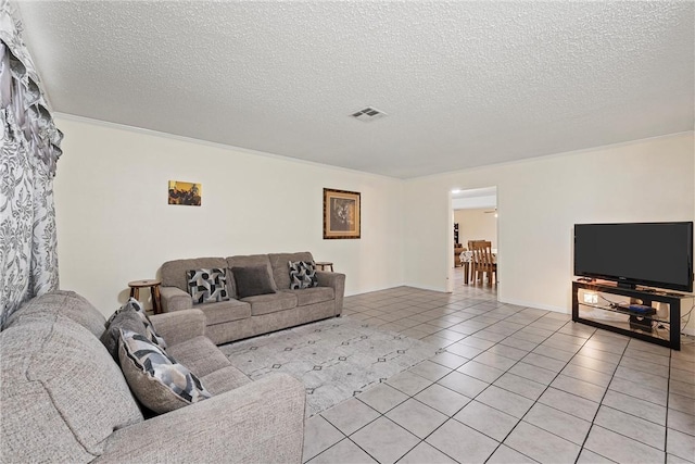 tiled living room with crown molding and a textured ceiling