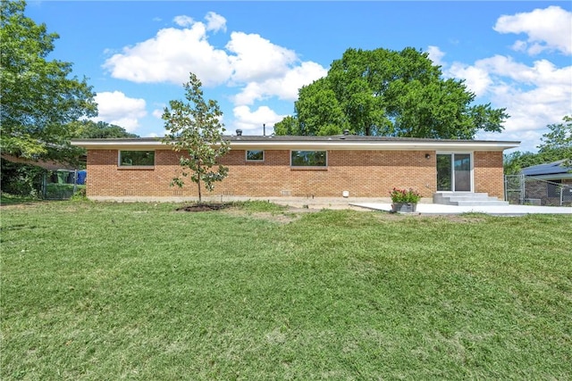 rear view of property with a yard