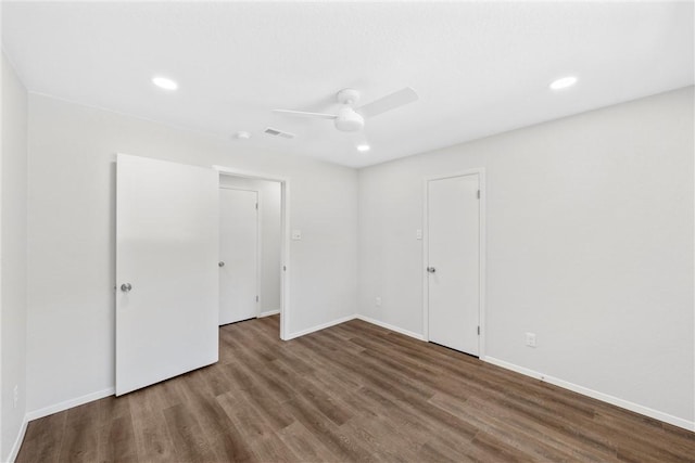 unfurnished room with ceiling fan and dark hardwood / wood-style floors