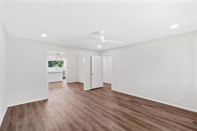 empty room featuring ceiling fan and dark hardwood / wood-style floors