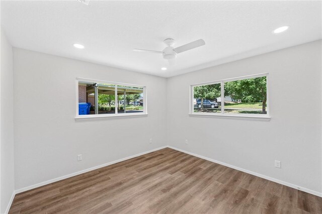 unfurnished room with hardwood / wood-style floors and ceiling fan