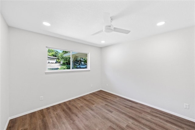 empty room featuring ceiling fan and hardwood / wood-style floors