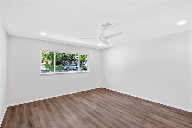 empty room featuring ceiling fan and dark wood-type flooring