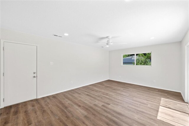 spare room with hardwood / wood-style flooring and ceiling fan