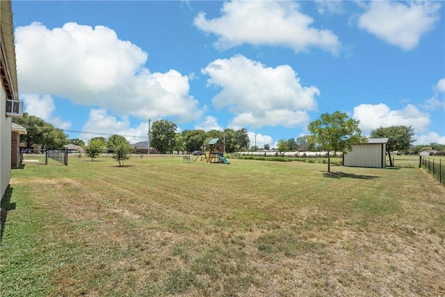 view of yard featuring a playground and a storage shed