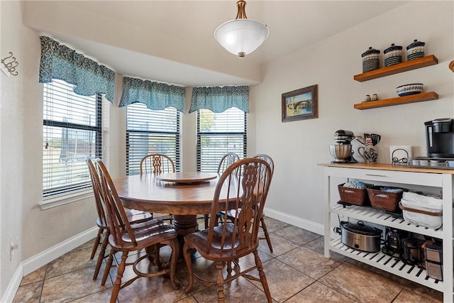 tiled dining space featuring a healthy amount of sunlight