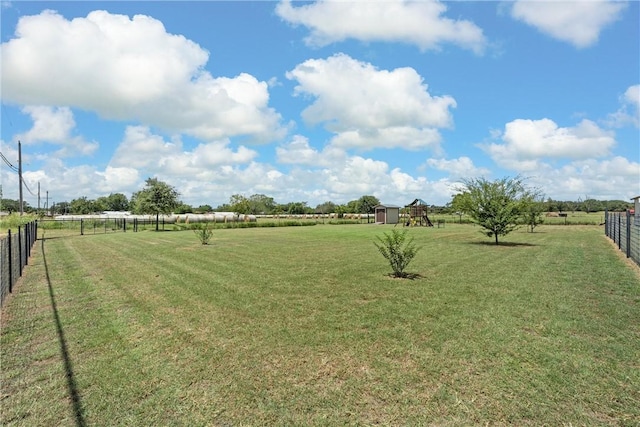 view of yard with a rural view and a playground