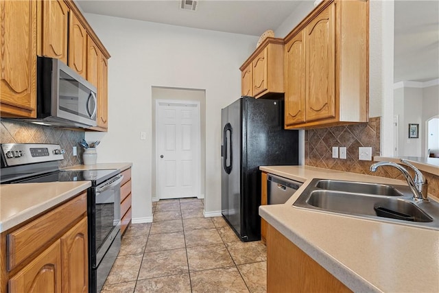 kitchen featuring light tile patterned flooring, sink, appliances with stainless steel finishes, and tasteful backsplash