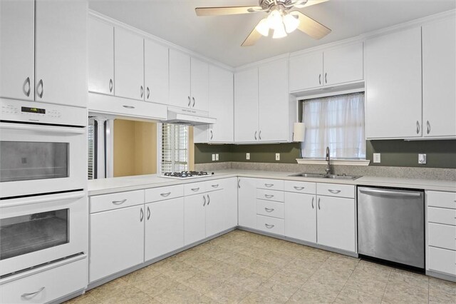 kitchen with white cabinetry, sink, and white appliances