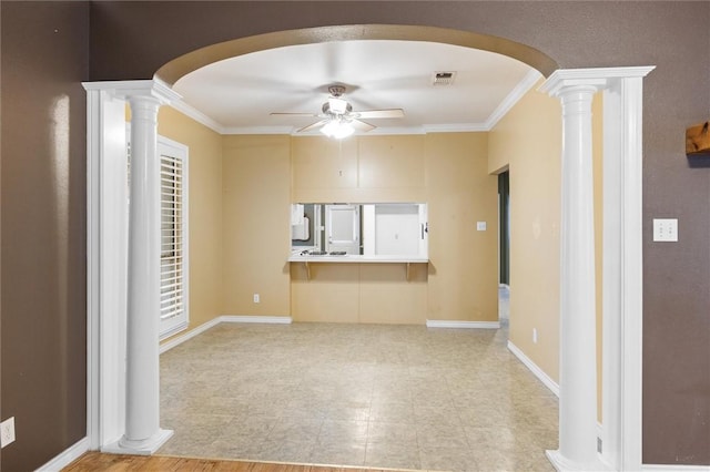 unfurnished living room featuring ornate columns, ceiling fan, and crown molding