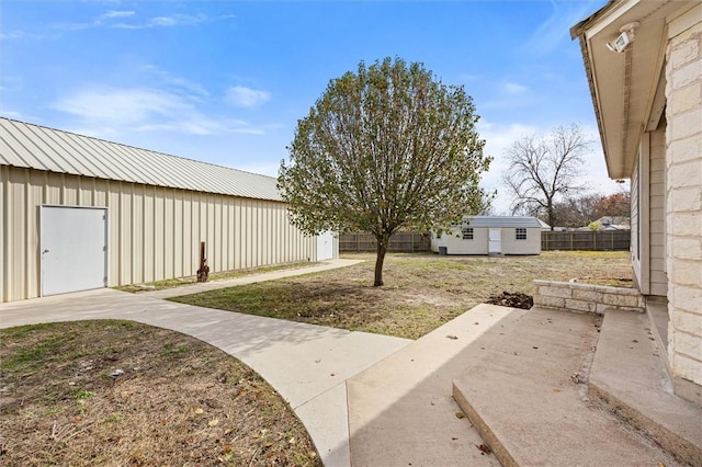 view of yard featuring a patio area and an outbuilding