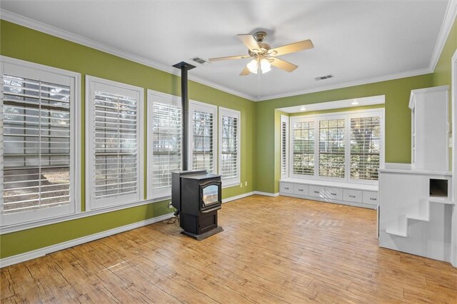 interior space featuring crown molding, ceiling fan, plenty of natural light, and light hardwood / wood-style floors