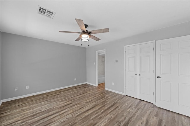 unfurnished bedroom with ceiling fan and light hardwood / wood-style floors