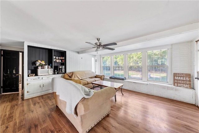 living room featuring wood-type flooring and ceiling fan