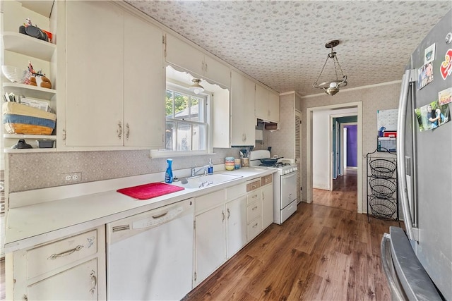 kitchen featuring white appliances, dark wood-type flooring, sink, pendant lighting, and white cabinetry