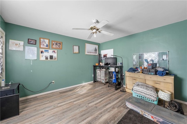 misc room with wood-type flooring and ceiling fan