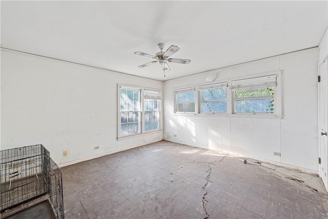 spare room featuring plenty of natural light and ceiling fan