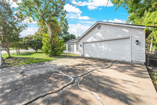 view of home's exterior with a lawn and a garage