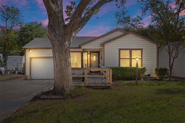 view of front of house featuring a yard and a garage